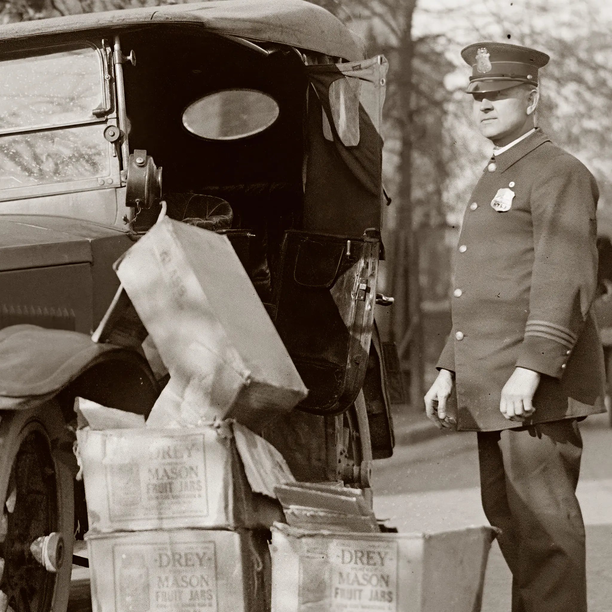 Close-up detail of prohibition police officer showing uniform details and confiscated liquor case evidence