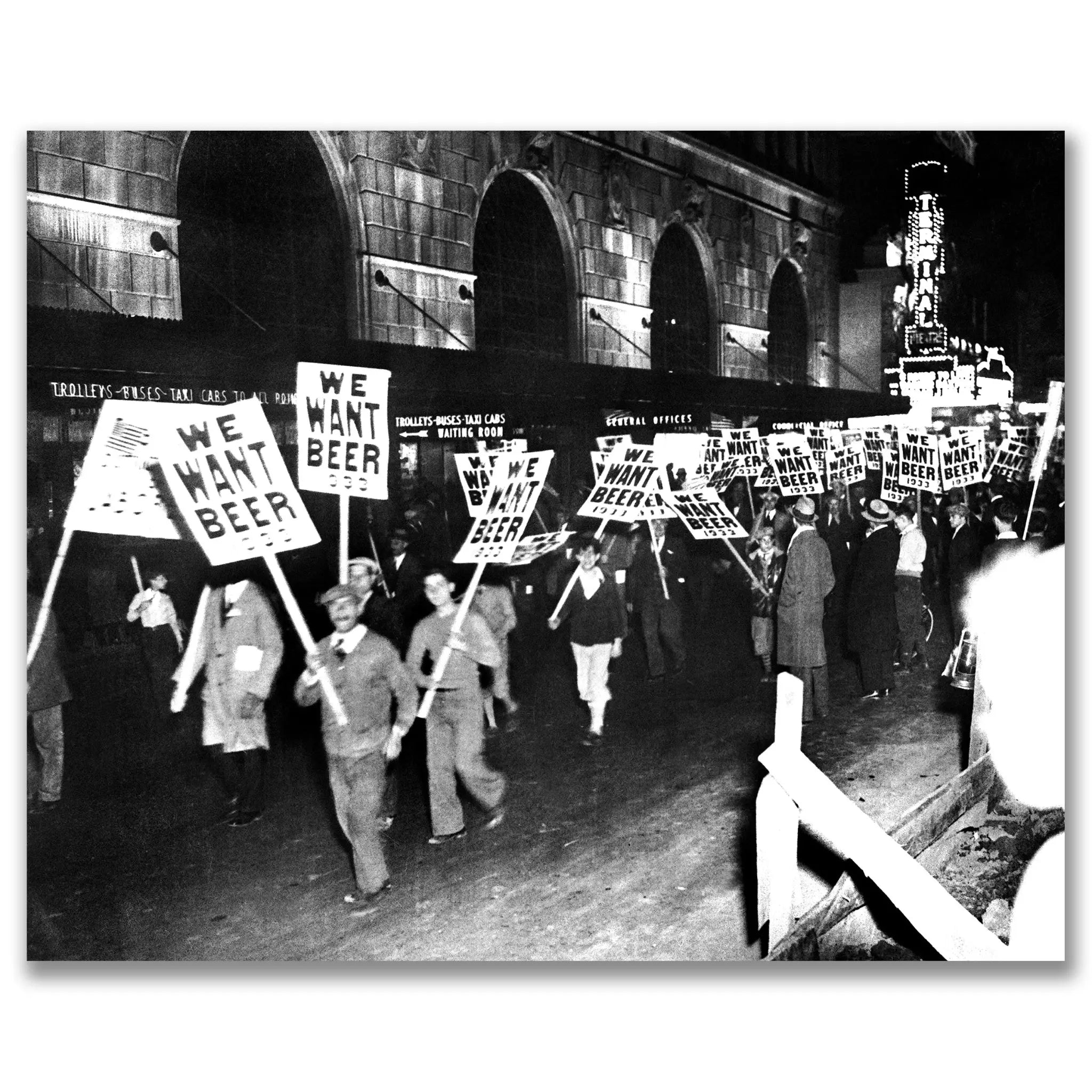 Historic WE WANT BEER protest march outside train station showing large crowd with anti-prohibition signs and architectural backdrop