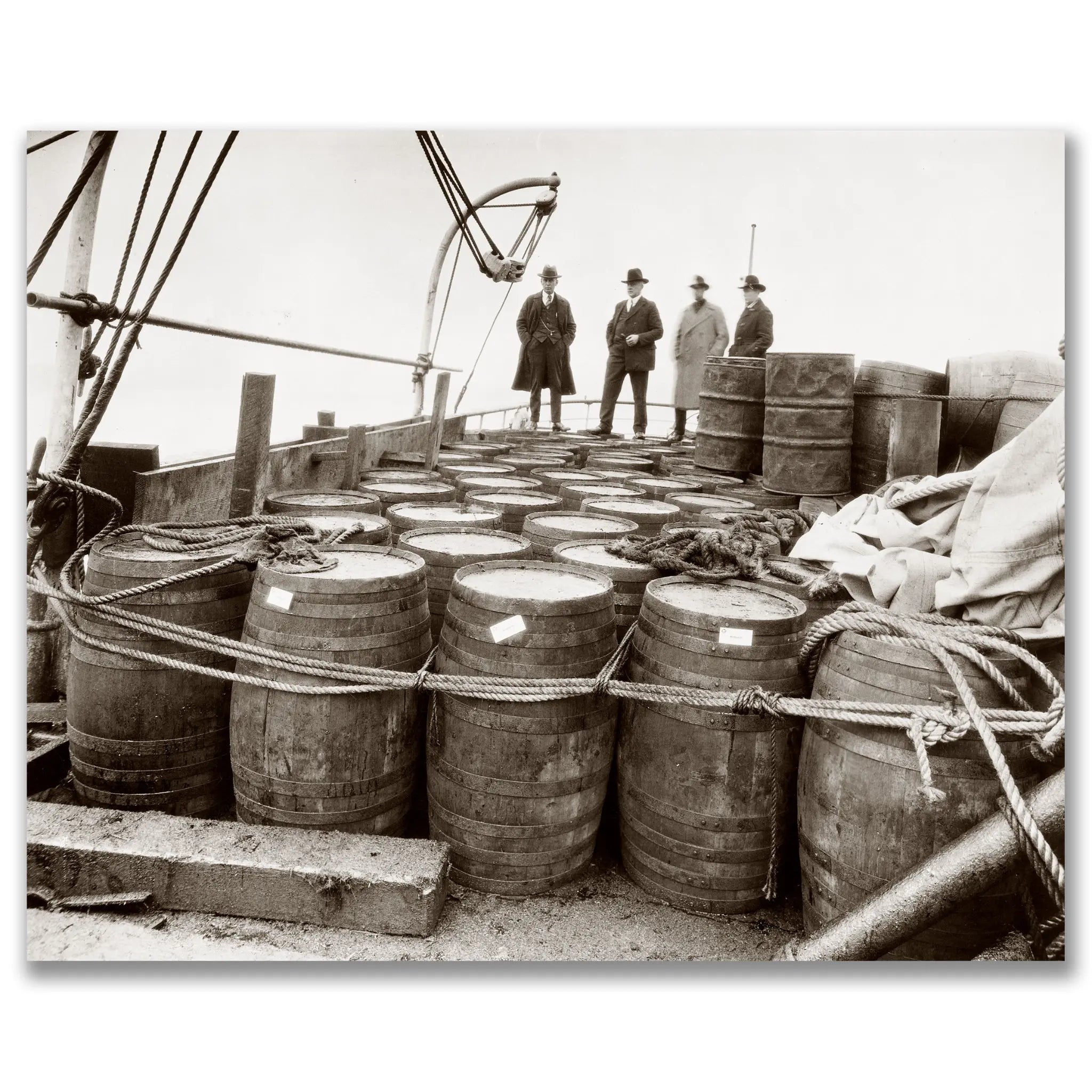 Prohibition era photograph showing federal agents with confiscated liquor barrels on ship deck during major seizure operation