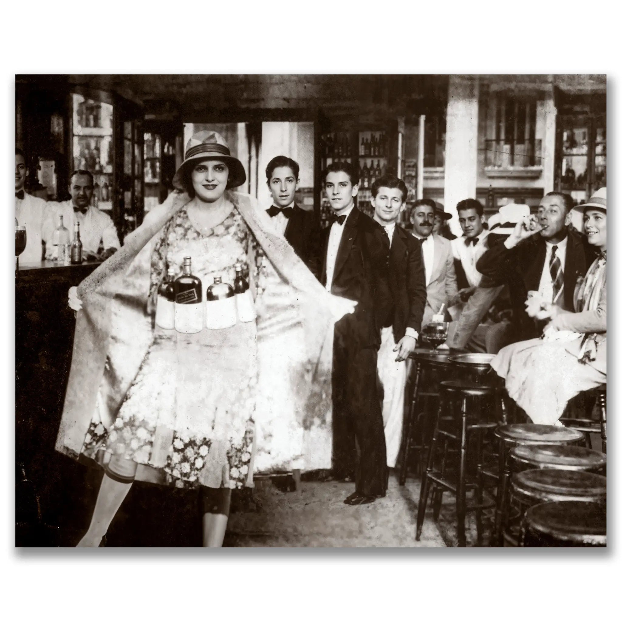 Historic prohibition era speakeasy photograph showing woman in bottle dress surrounded by patrons in illegal underground bar