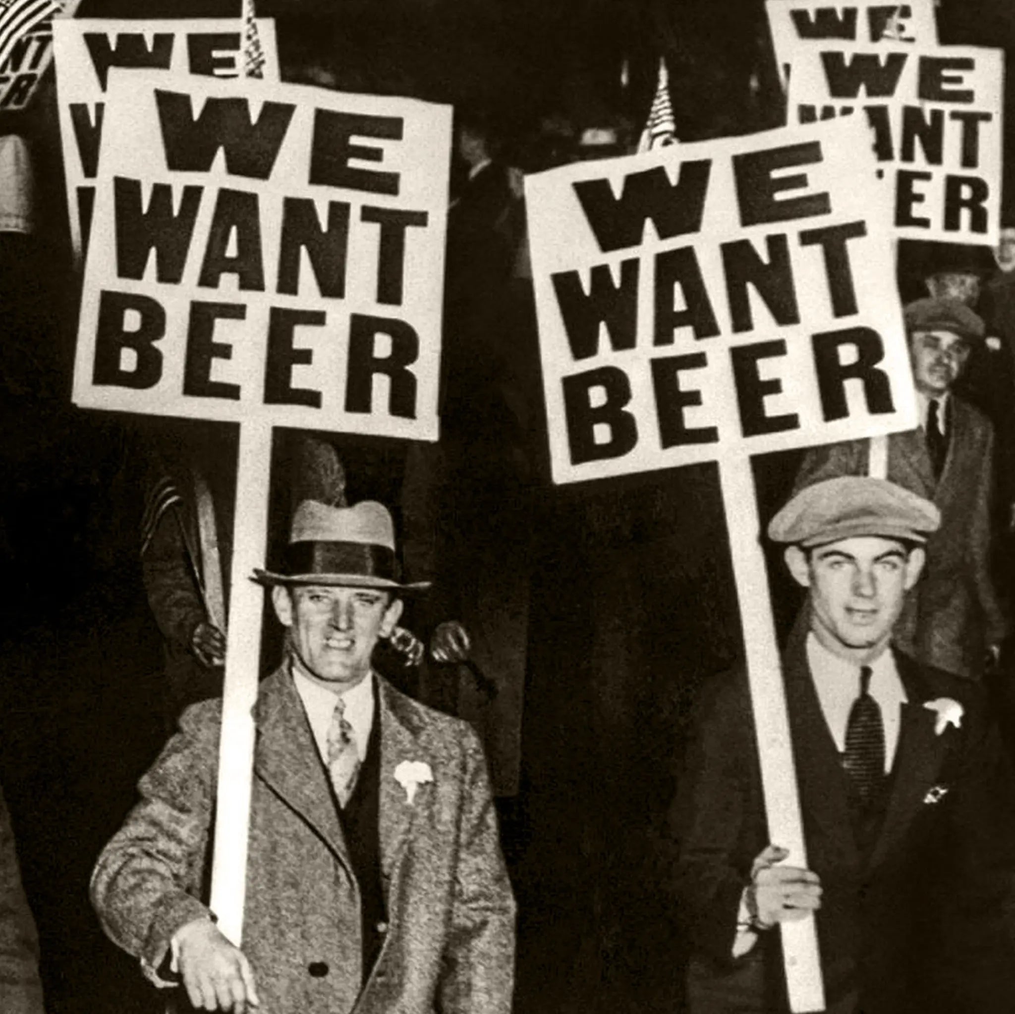 Close-up detail of WE WANT BEER protest signs showing clear messaging and determined faces of anti-prohibition demonstrators